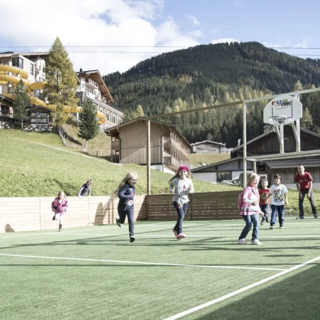 Kinder spielen Fußball auf einem Sportplatz