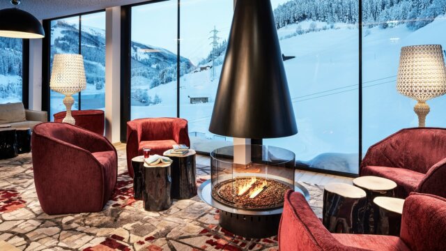 Gemütlicher Raum mit Kamin und alpine Aussicht