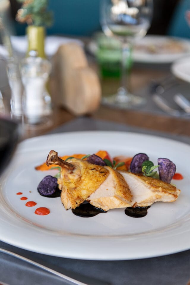 Gegrilltes Huhn mit buntem Gemüse und Sauce.