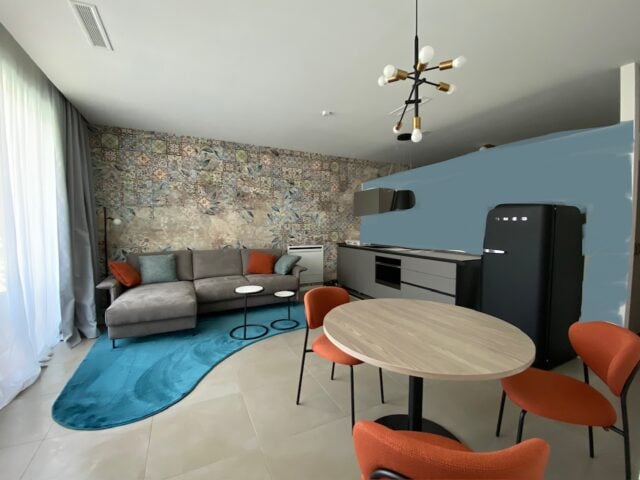 Moderne Wohnküche mit Sofa und Esstisch.